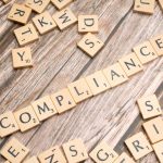compliance written on small wooden tiles